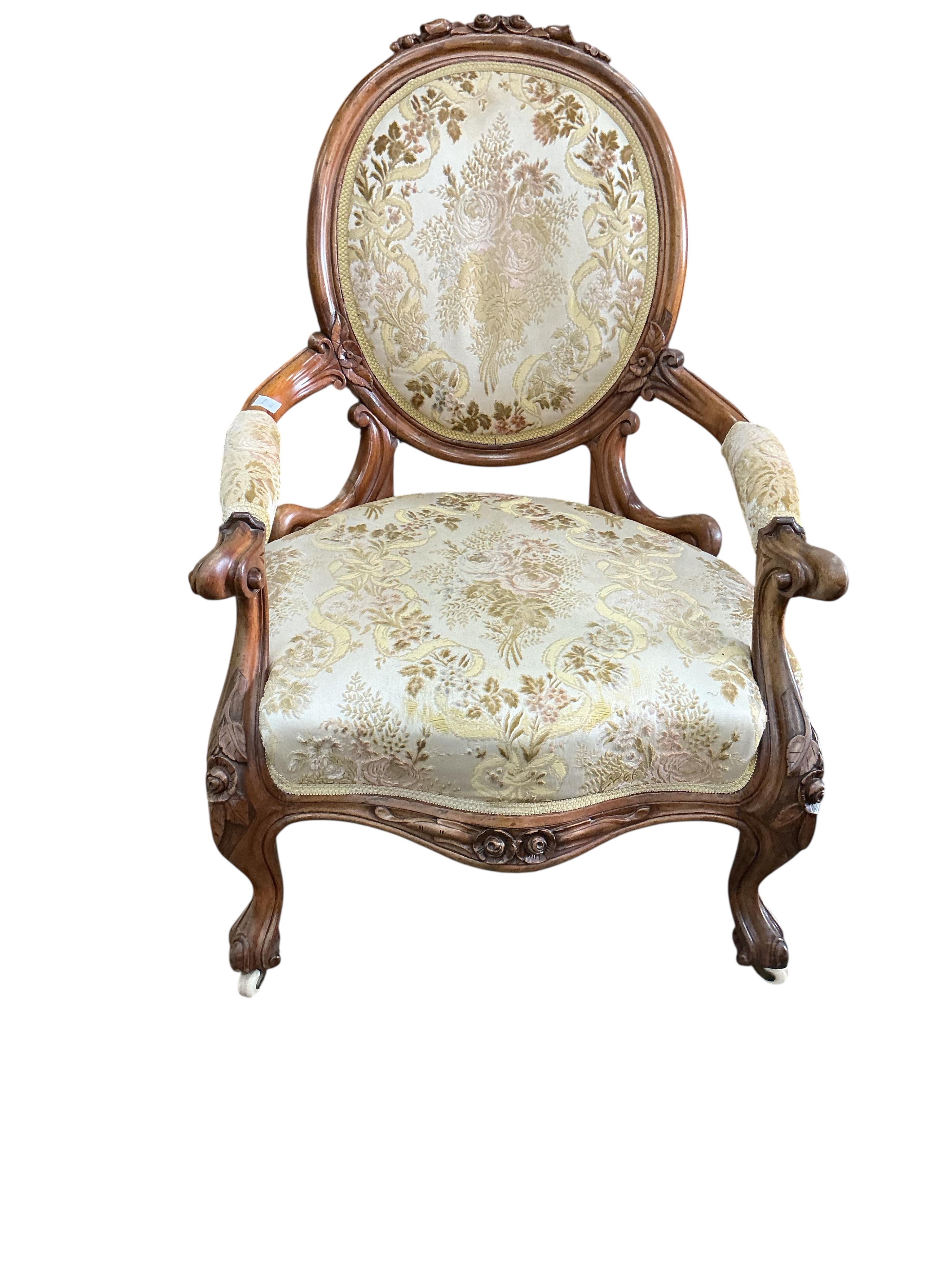 A Victorian faded rosewood spoon back open armchair, width 70cm, depth 62cm, height 100cm